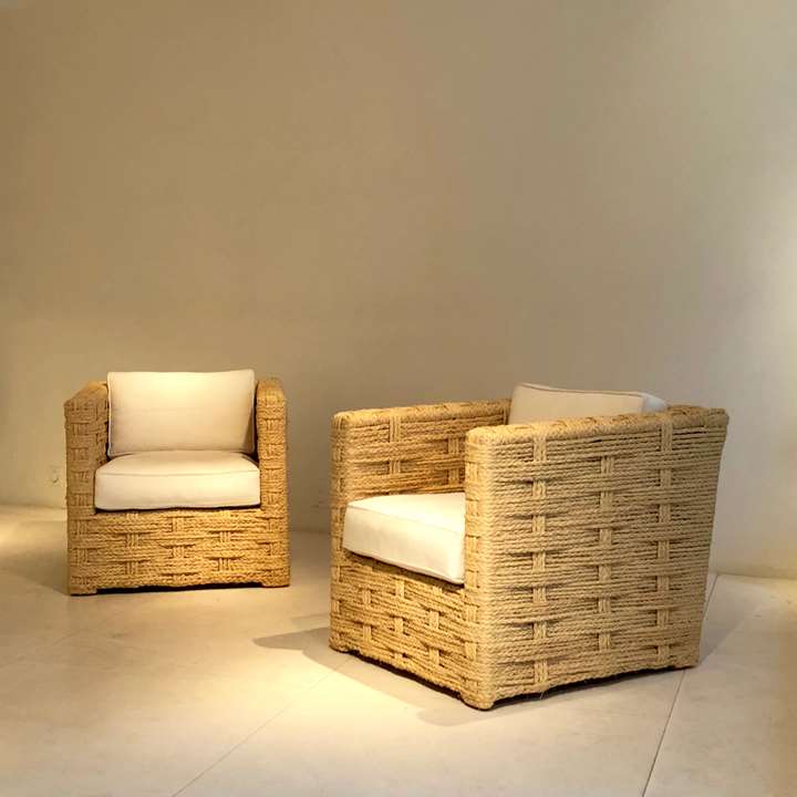 Pair of chairs and two ottomans, wooden structure trimmed with braided raffia